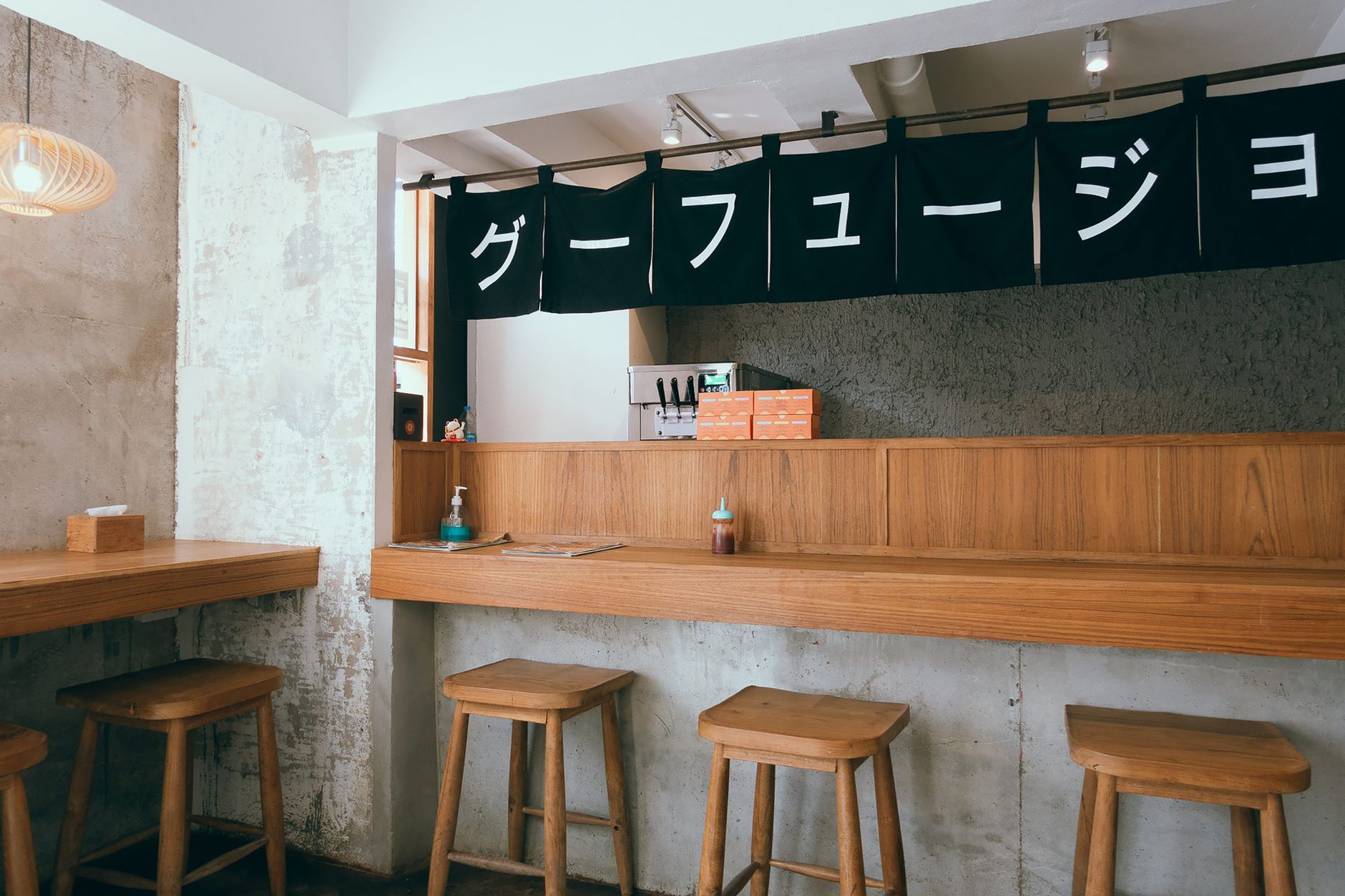 A lively izakaya bar with friends toasting drinks under warm lighting