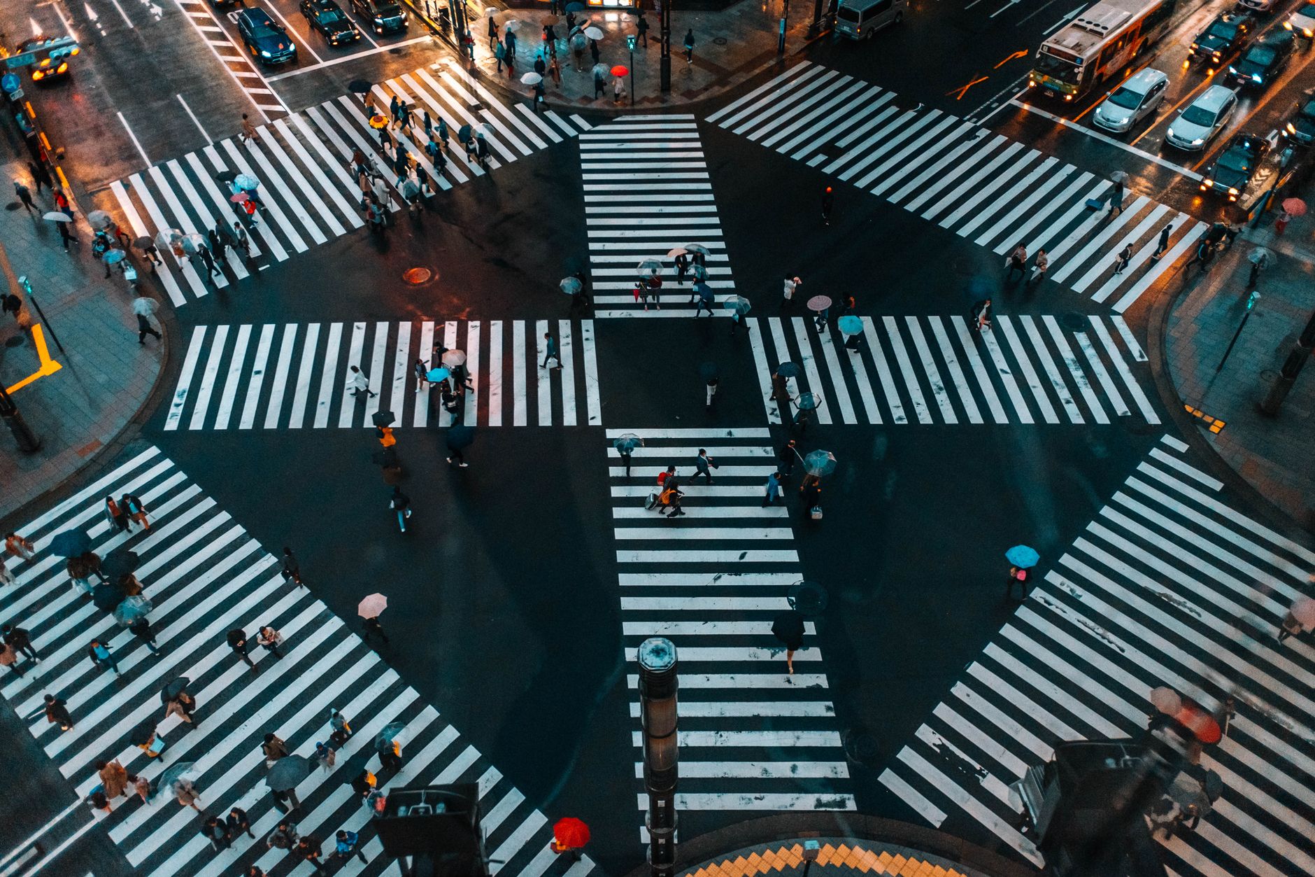 Aerial view of Shibuya Crossing packed with pedestrians crossing in multiple directions during the day