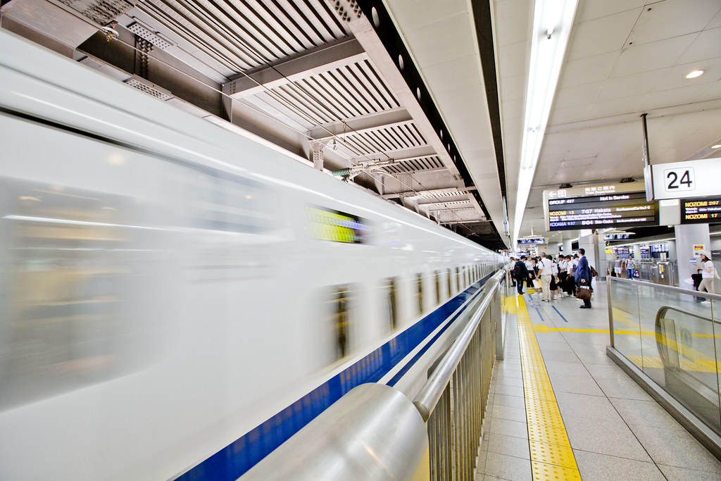 A shinkansen train at a station platform in Japan.