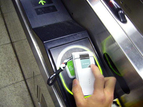 A transit IC card being tapped at a gate.